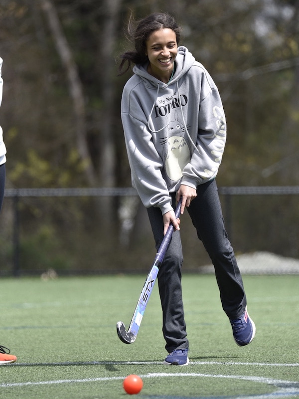 Beacon Academy student playing field hockey